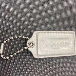 Coach tag  2 & a half “ long 1 & a half “ wide In Silver